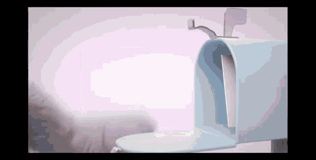 a blue mailbox with a letter in it against a pink background