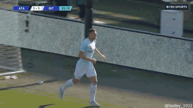 a soccer player is running on a field with a score of 1-1