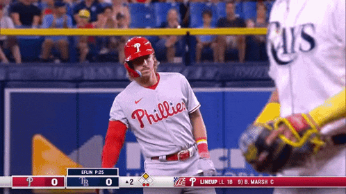 a phillies baseball player stands in front of the catcher