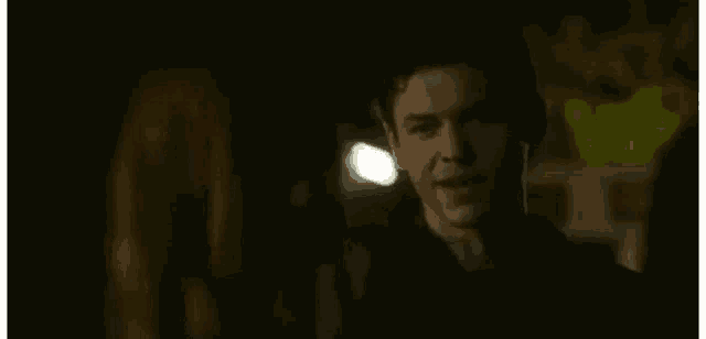 a man and a woman are standing next to each other in the dark .