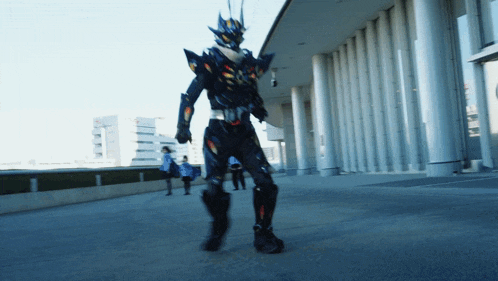 a man in a superhero costume walks down a street