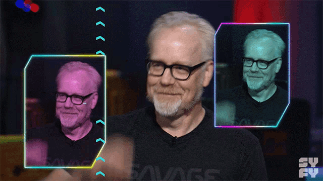 a man wearing glasses and a black shirt that says savage