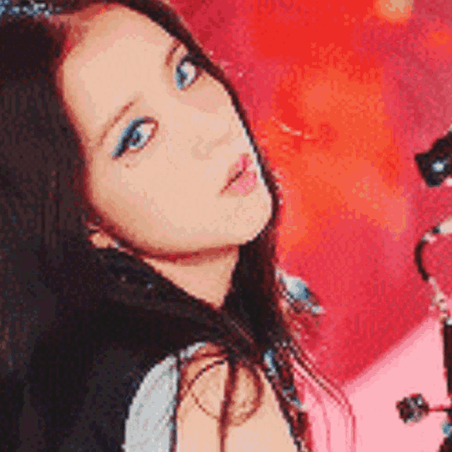 a close up of a woman 's face with blue eyes
