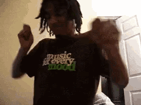 a man wearing a t-shirt that says music for every mood is dancing in a room .