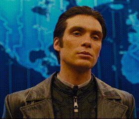 a man with a zipper around his neck stands in front of a blue background