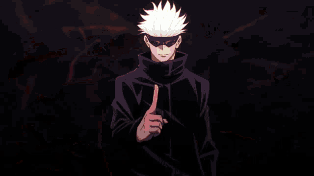 a man in a black jacket is holding a red object in his right hand .