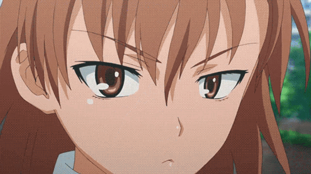 a close up of a girl 's face with a serious expression