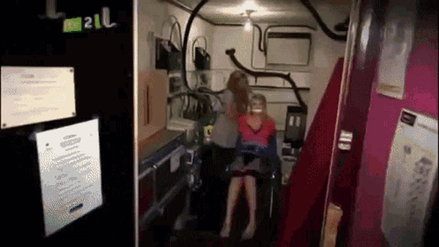 a woman is sitting in a chair next to a sign that says rv 21l