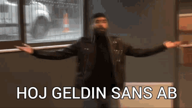 a man with his arms outstretched and the words hoj geldin sans ab written on the bottom