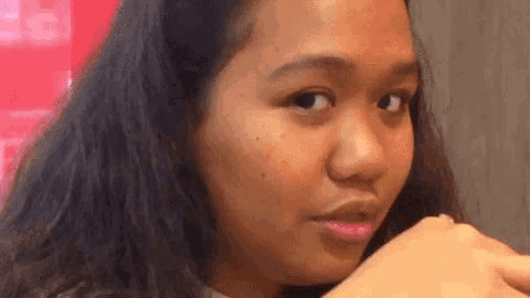 a close up of a woman 's face with a ring in her lip