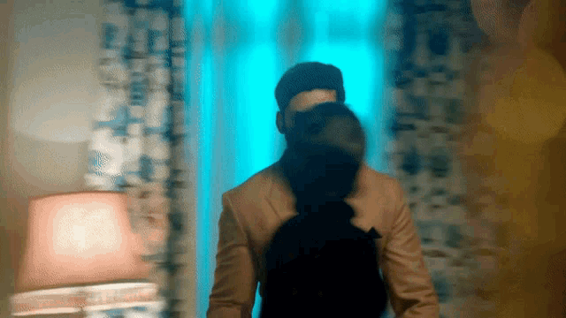 a blurry picture of a man and woman standing in front of a window
