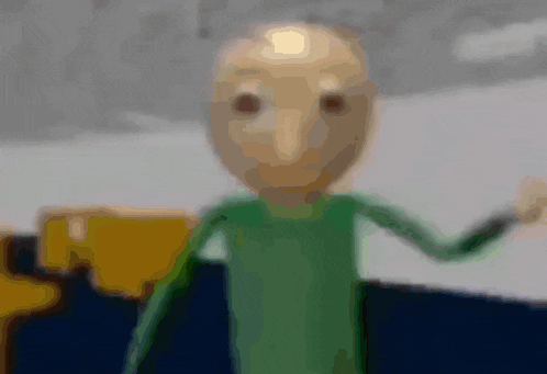 a blurry picture of a cartoon character wearing a green shirt and waving his hand .