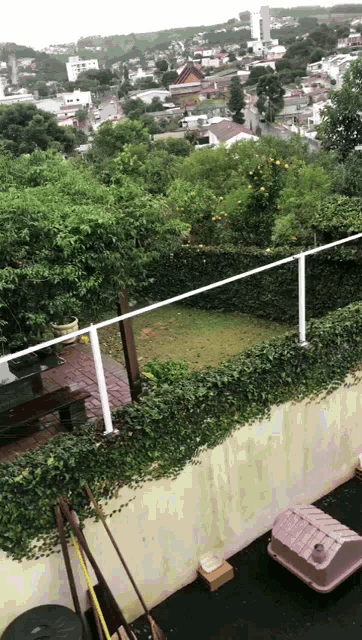 a view of a city from a balcony with a fence