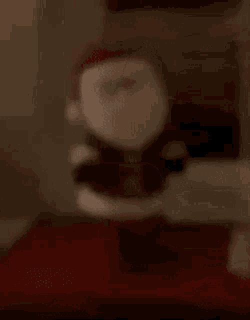 a blurred image of a santa claus statue with a hat on .
