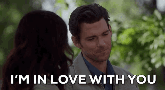 a man and a woman are looking at each other and the man says i 'm in love with you