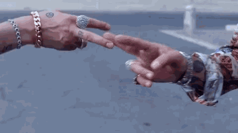 a man and a woman are touching each other 's fingers in a parking lot .
