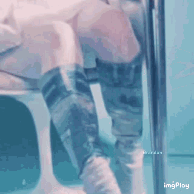 a person 's legs are shown in a blurry photo with brandon written on the bottom right