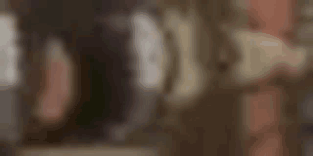 a blurry picture of a person standing in a room with a blurred background .