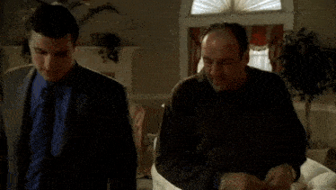 two men are talking in a living room and one of them says you know that 's a nice suit ..