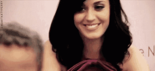 a close up of a woman 's face with the words i heart katy perry on the bottom