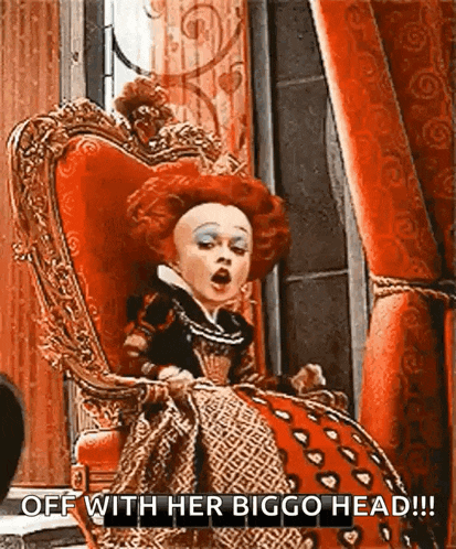 the queen of hearts from alice in wonderland is sitting in a red chair