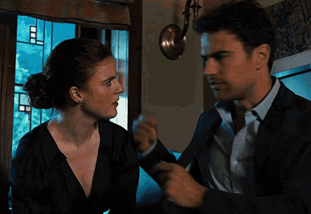 a man and a woman are standing next to each other