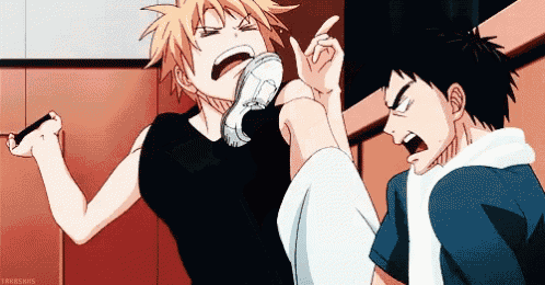 a couple of anime characters are standing next to each other and fighting .