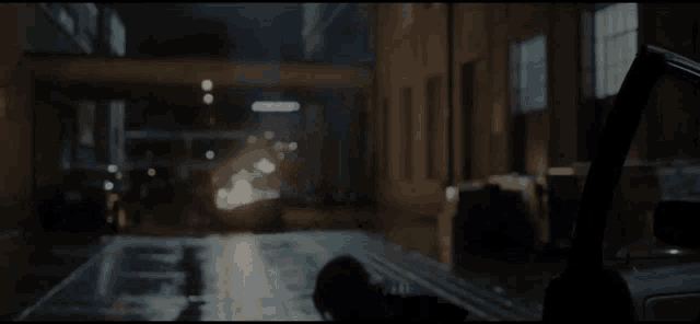 a car is driving down a dark city street