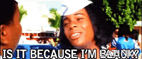 a woman in a graduation cap is talking to a man in a white hat .
