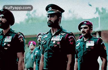 a group of soldiers are standing in a line in a military parade .