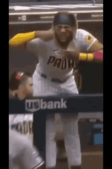a san diego padres baseball player stands in front of a bank sign