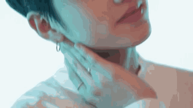 a close up of a person 's neck with a hand on it .