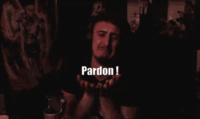 a man in a dark room with the words pardon written on the bottom