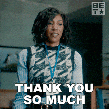 a woman with a lanyard around her neck is giving a thank you so much sign
