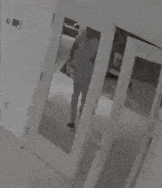 a black and white photo of a person 's feet in a doorway .