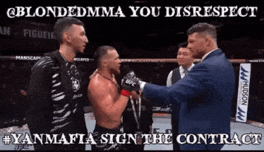 a man in a suit shakes hands with another man in a boxing ring with the caption " @blondedmma you disrespect "