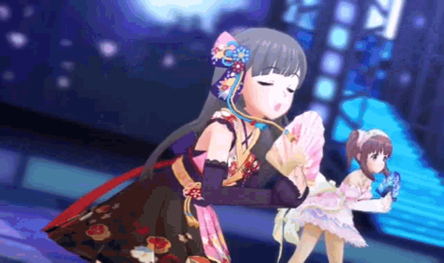 two anime girls are dancing on a stage and one is holding a fan in her hand