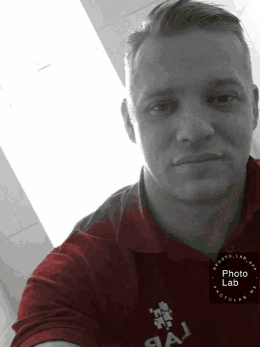 a man wearing a red shirt that says photo lab on it