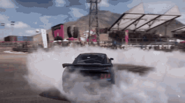 a car is drifting in a video game and smoke is coming out of it