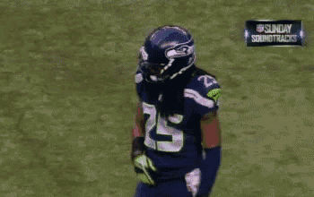 a football player with the number 5 on his jersey stands on a field