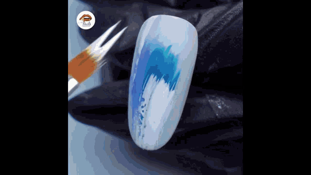 a close up of a nail being painted with a brush