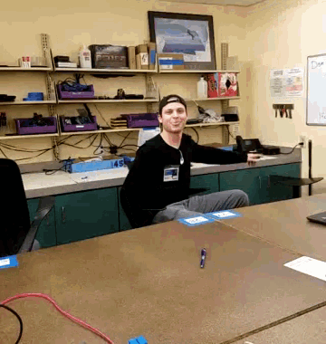 a man sitting at a table with a name tag that says ' tnt '