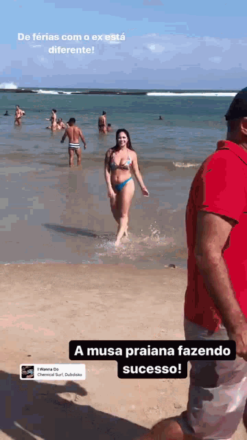 a woman in a bikini is walking out of the water