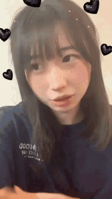 a girl with freckles is wearing a shirt that says good yao juice