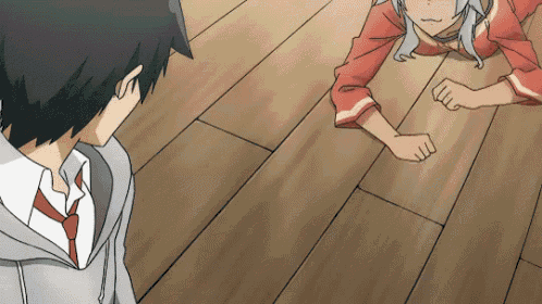 a boy and a girl are standing on a wood floor
