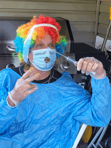 a man in a clown costume holding a syringe and a spoon