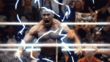 a man is standing in a boxing ring with lightning coming out of him .