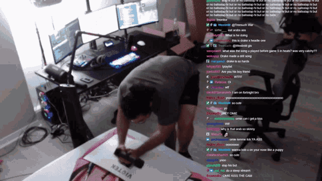 a man is kneeling down in front of a desk with a sticker that says viktor on it