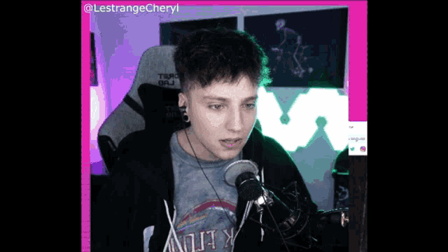 a young man sitting in front of a microphone wearing a t-shirt that says ' heavy metal ' on it