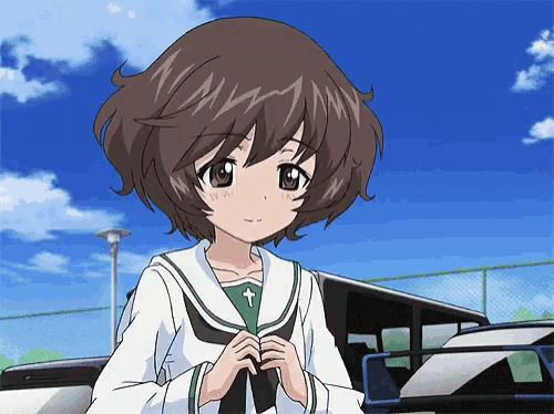 a girl with a cross on her shirt stands in front of a car